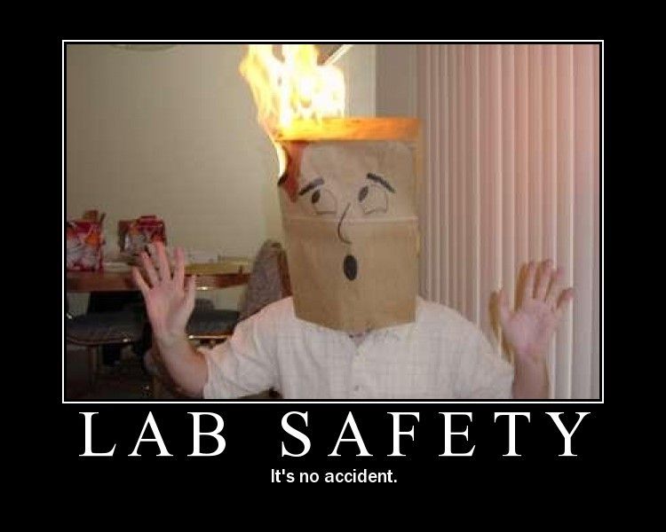 Reads: Lab Safety. It's no accident. Person has a paper bag on their head and it's on fire. 