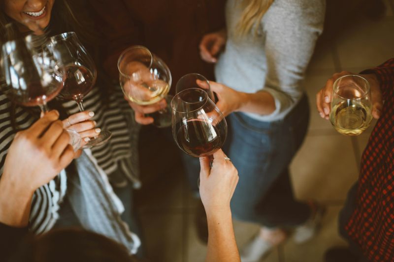People drinking wine at a party.
