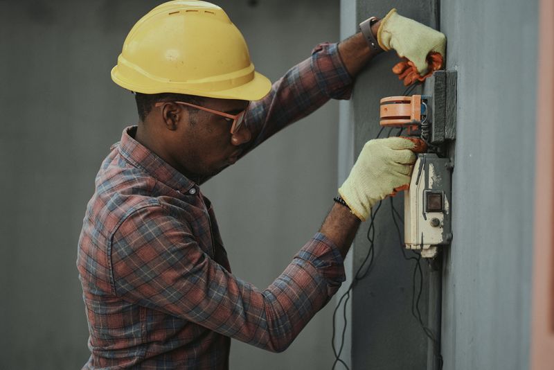 Man installing electrical device