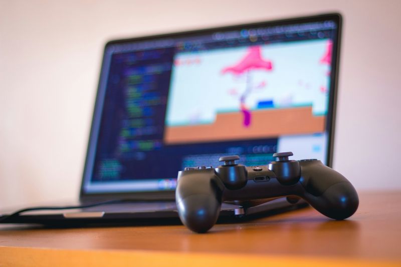 A person developing an indie game on a laptop.