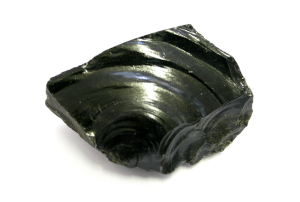 Image of an Obsidian igneous extrusive rock with a glassy-black- smooth texture without patterns of individual crystals