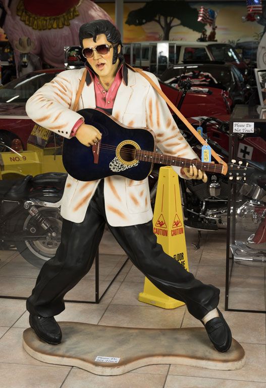 A life-size statue of singer Elvis Presley playing guitar and dancing