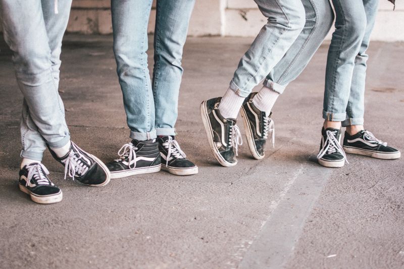 4 people, standing in different leg pointe positions.