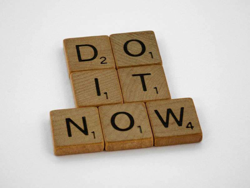 Scrabble tiles spelling, 'Do it now'.