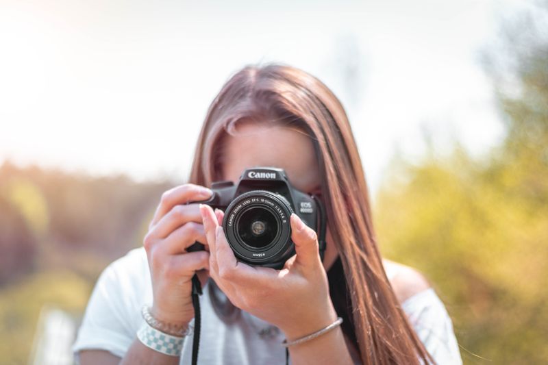 A women taking a photo with a professional camera. 