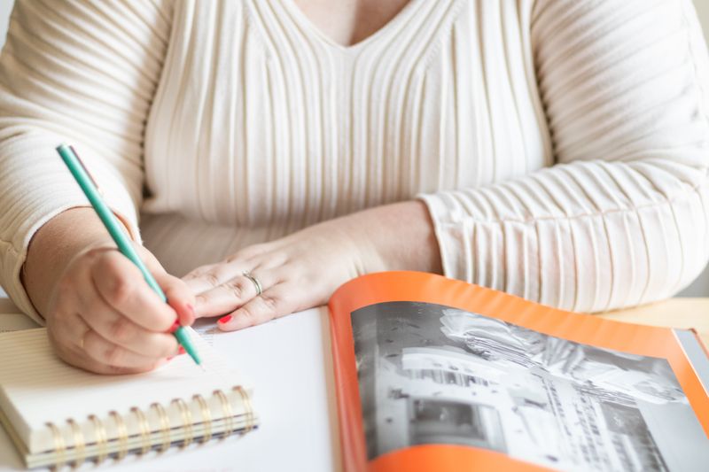 Women taking notes in a spiral pad