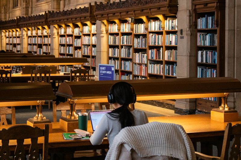 Photo of woman studying in a library.