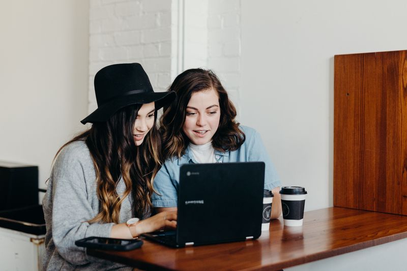 Two team members collaborating on a computer