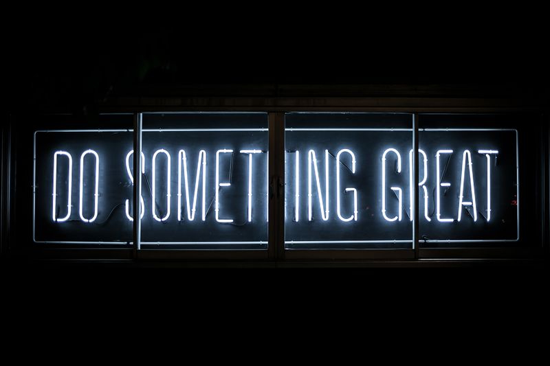 Neon lights that say, 'Do something great'