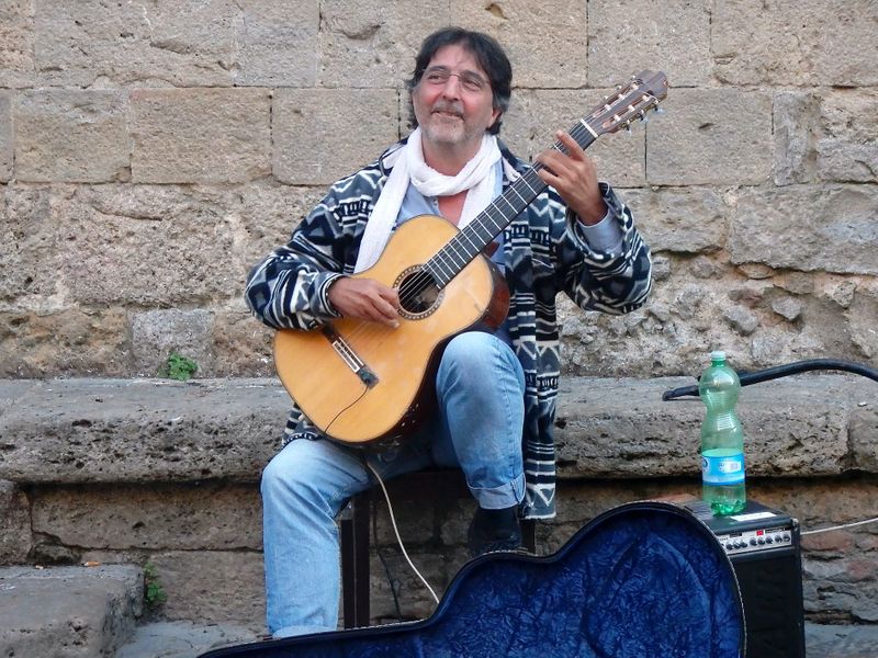 Man holds a classical guitar.