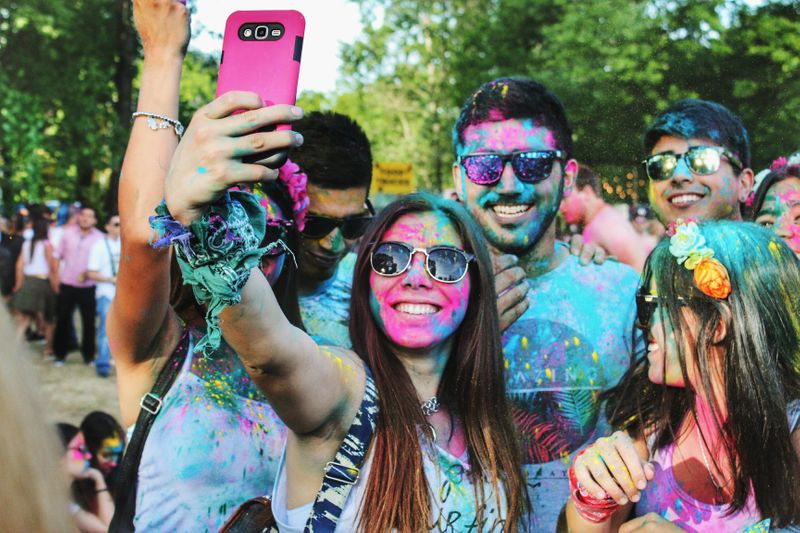 A group of friends taking a selfie at a Holi celebration