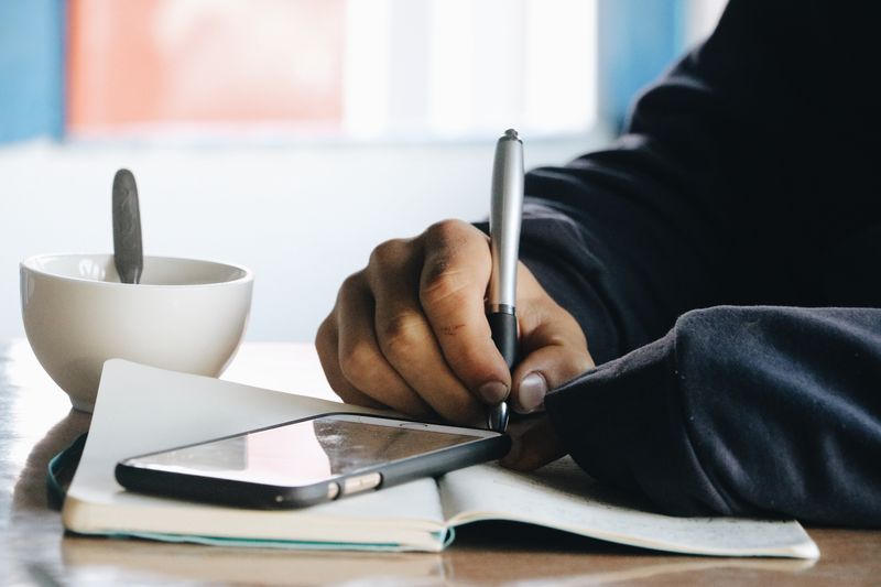 an image of a person taking notes from their phone