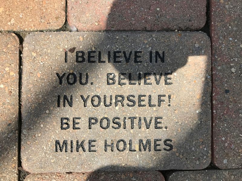 A stone with a Mike Holmes quote: 'I believe in you. Believe in yourself! Be positive.'