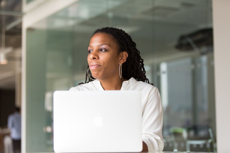 A woman on her laptop looking like she's making a decision