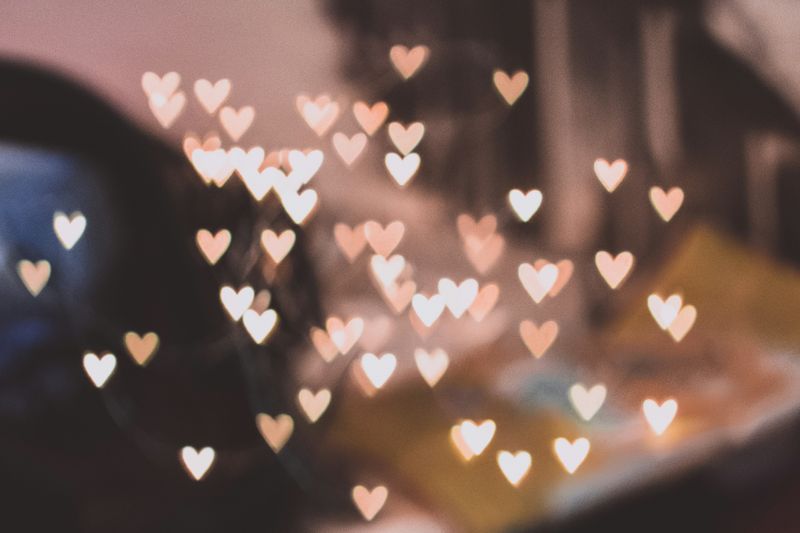 Many little hearts in various shades of pink, grouped together almost like a wind-chime.