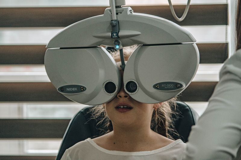 Girl having an eye exam using the Phoropter.