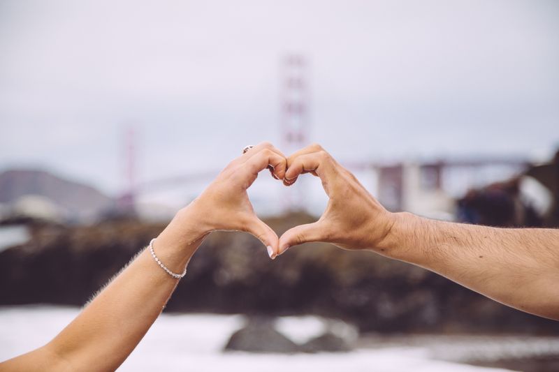 Two hands making a heart.