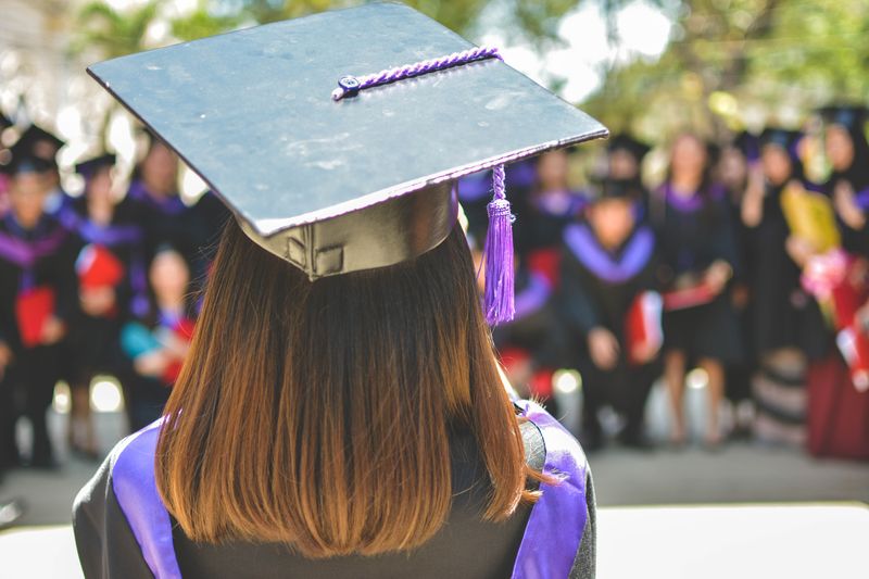 A young woman wearing a graduation cap.