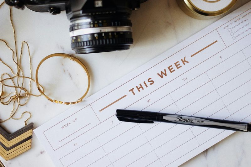 A weekly planner on a desk.