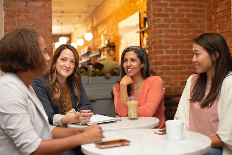 People sitting around tables having a conversation.