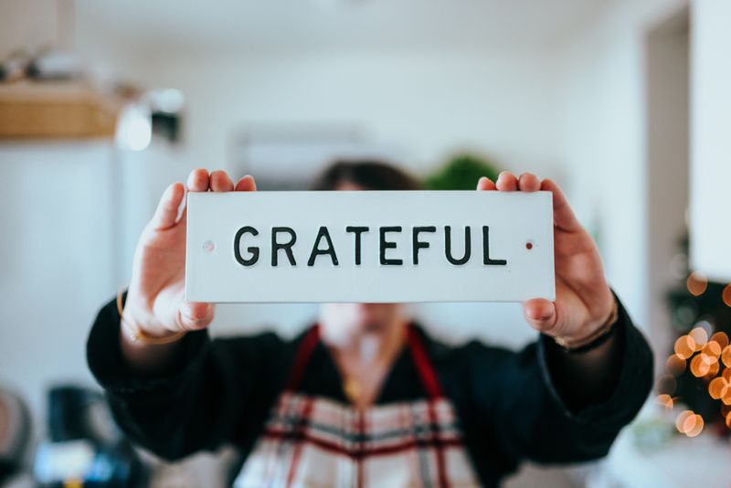 Person holding a sign that says 'Grateful