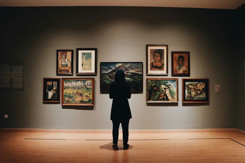 A man appreciating art work at a museum. 
