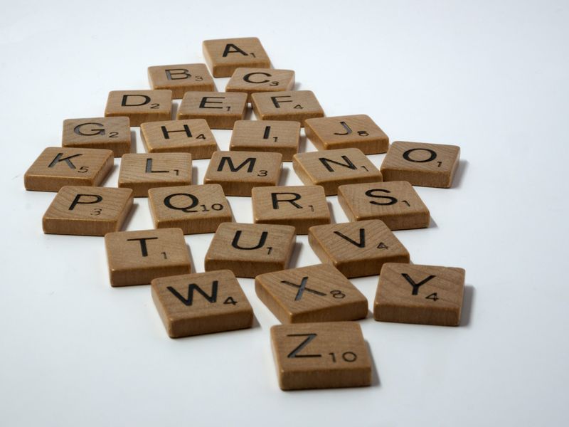 A series of consonant and vowel Scrabble tiles
