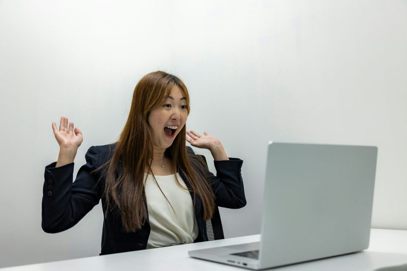 A woman happy at her desk.