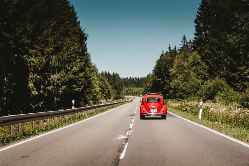 Red car on a road trip