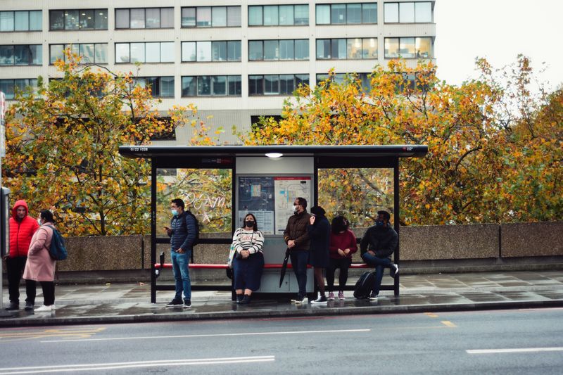 People sitting at a bus stop.