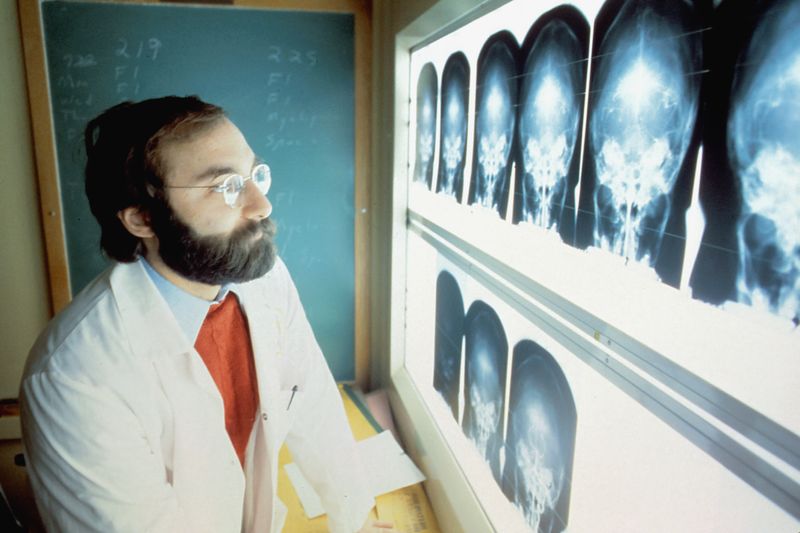A doctor using medical technology to analyze medical images x-rays.