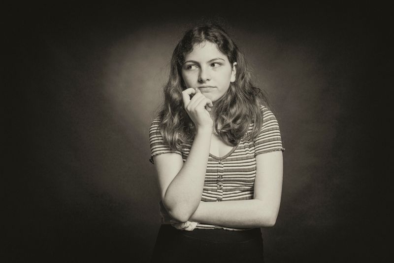 Woman resting her head on her hand and thinking about things.