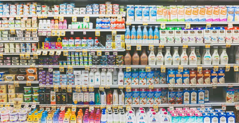 A grocery store aisle with many products on the shelf.