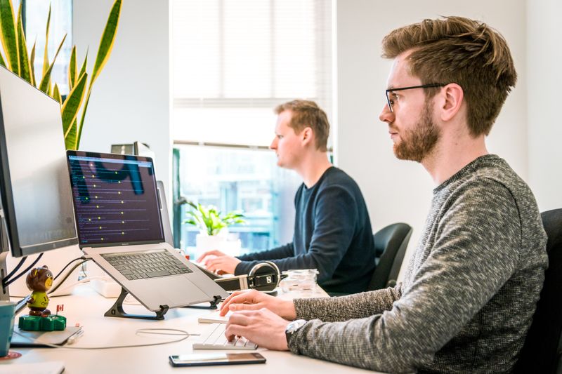 Two men working on computers