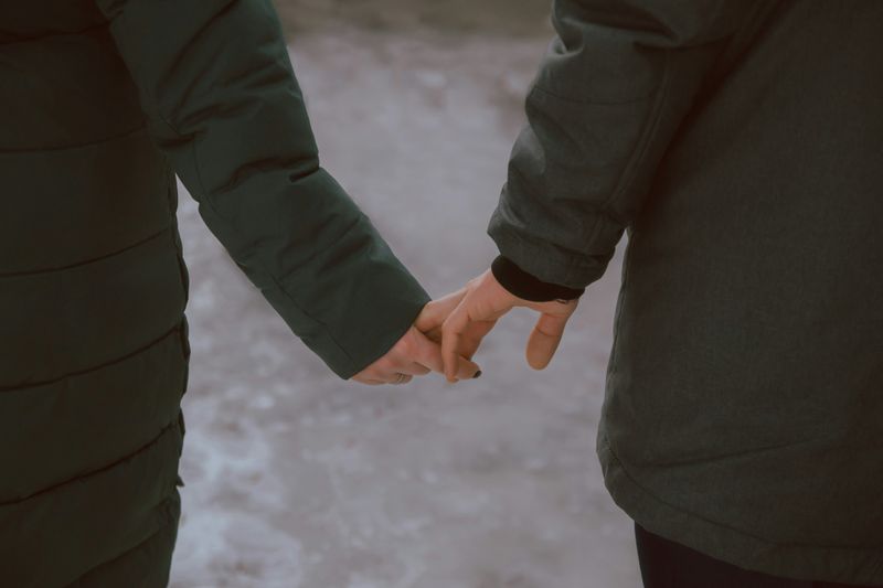 Two people holding hands.