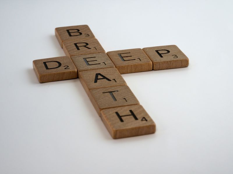 Scrabble blocks that spell 'deep breath'.