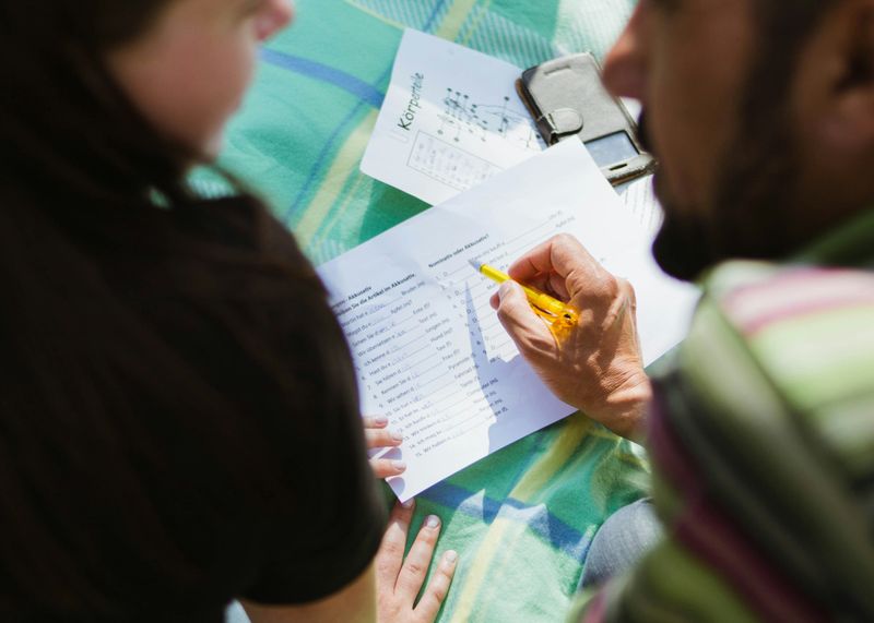 Two people having a discussion, with paper in front of them.