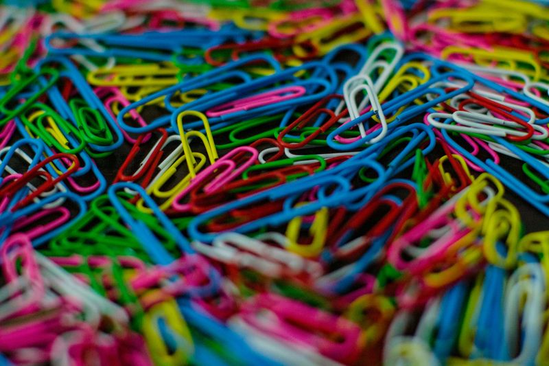 A pile of multi-colored paper clips. 