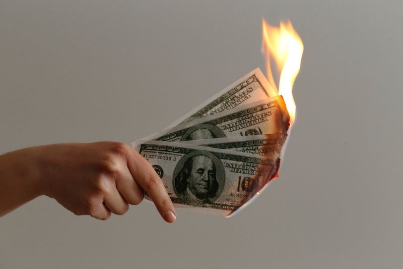 four money bills on fire