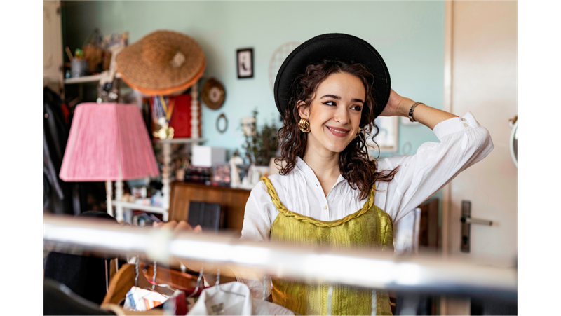 A woman wearing funky outfit in a vintage store.
