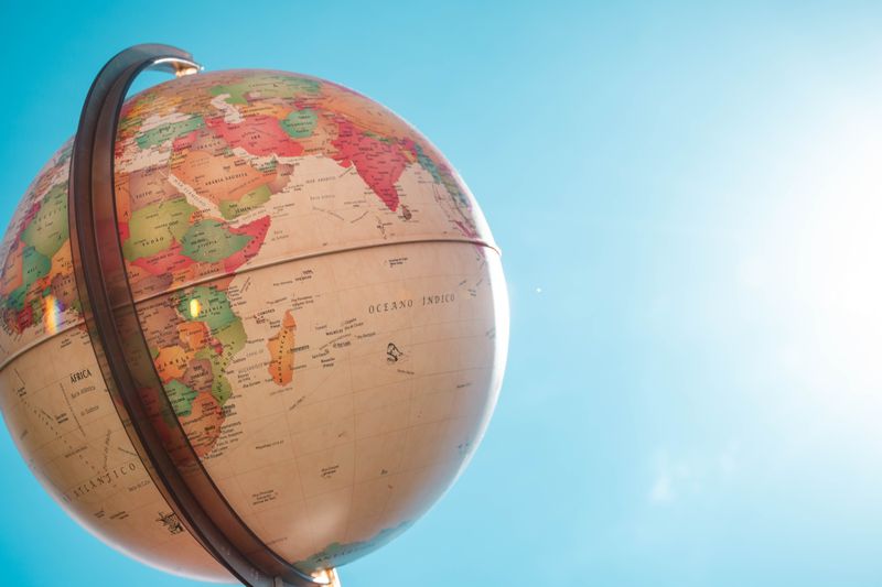 A globe in front of a blue sky.