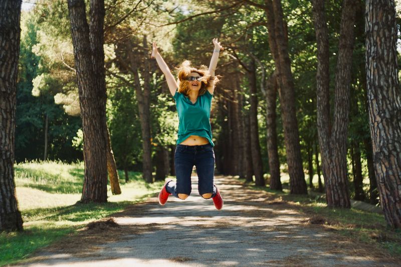 Woman jumping in the air with her arms up