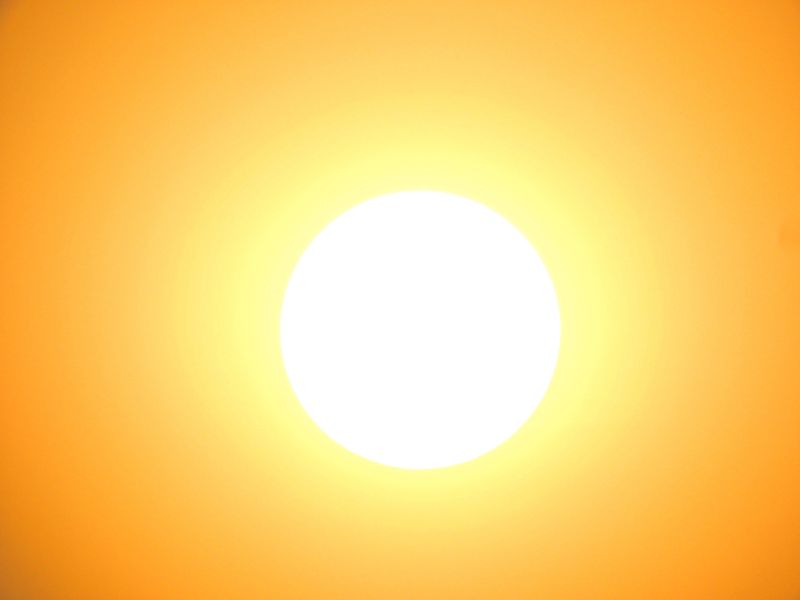 The sun shining in the sky.