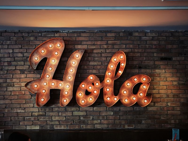 Electric sign, reading 'Hola.'