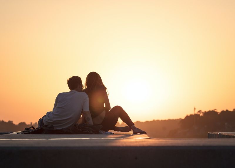 A couple watching the sun set.