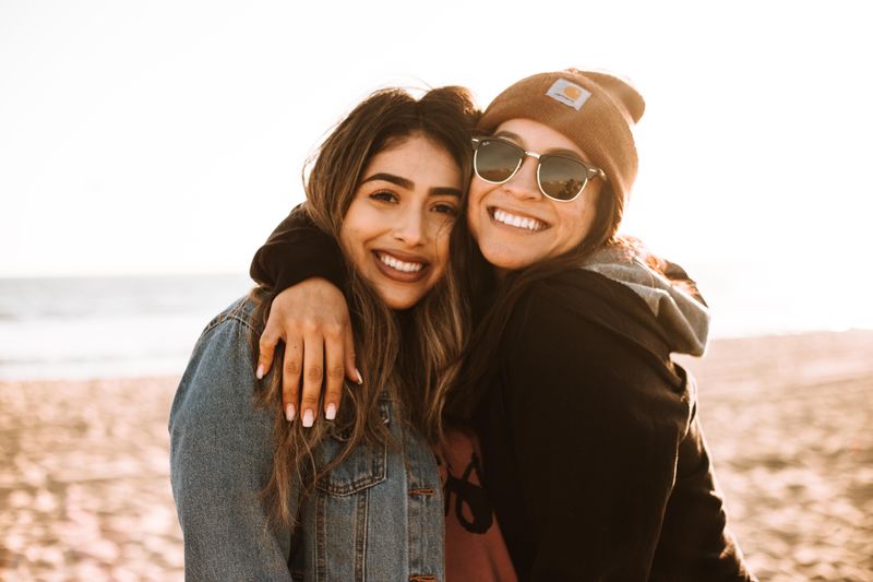 An image of two women hugging and posing for a picture.