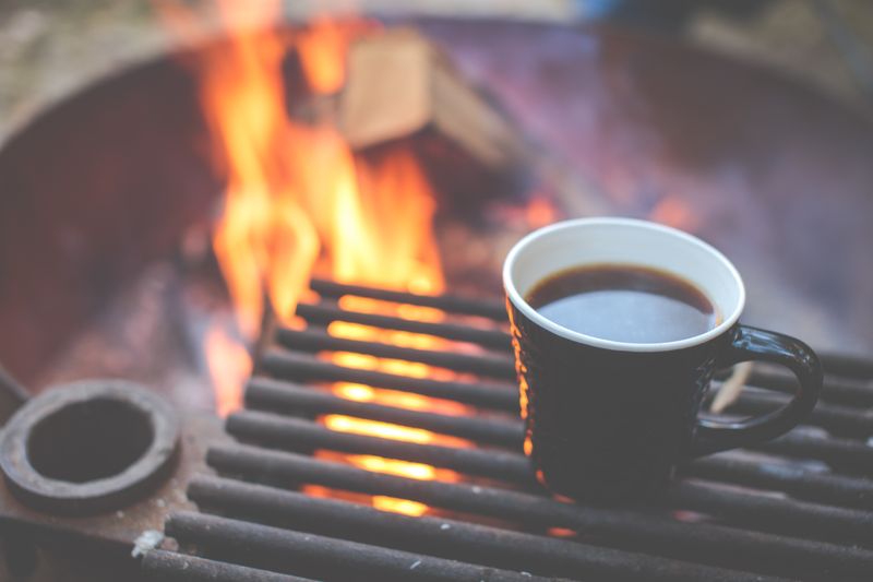 A great cup of coffee over a campfire (Photo by Alex Holt on Unsplash)