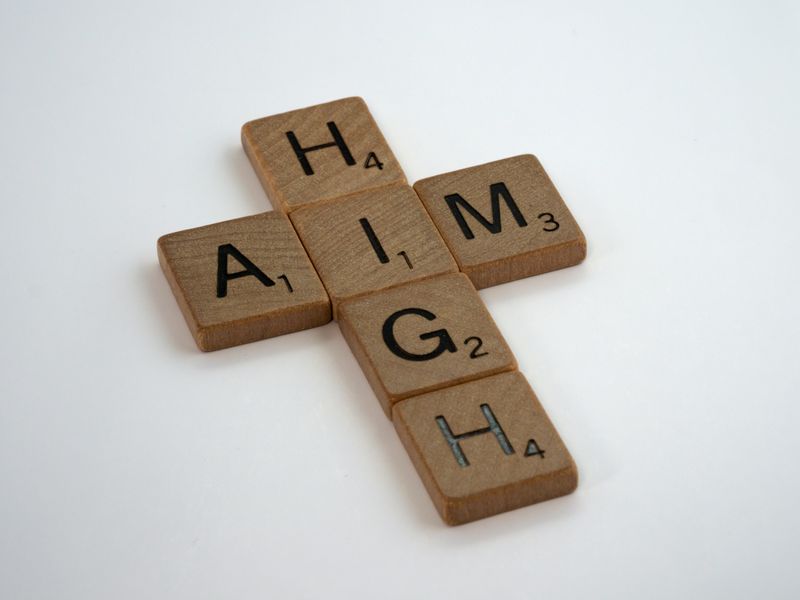 Scrabble tiles spell out the words 'Aim' and 'High'
