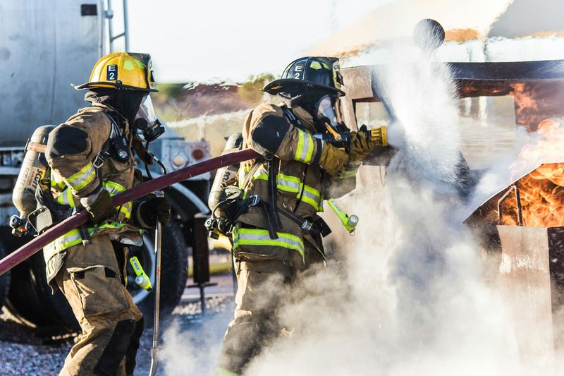 Two firefighters handling a hose