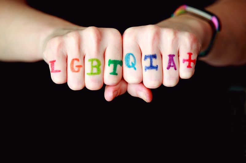 A color coded 'LGBTGIA+' marked on someone's knuckles